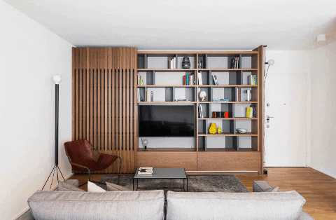 a living room with a TV and a bookshelf